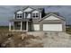 Inviting two-story home boasting a two-car garage and a covered front porch at 210 Aster Way, Greenfield, IN 46140