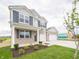 Beautiful home with a covered porch, well-maintained lawn, and a convenient two-car garage at 210 Aster Way, Greenfield, IN 46140