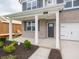 Inviting front porch with classic white columns, brick accents, and meticulous landscaping at 210 Aster Way, Greenfield, IN 46140