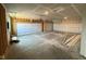 An unfinished two-car garage with bare walls and a concrete floor awaits customization and storage solutions at 210 Aster Way, Greenfield, IN 46140