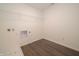 Functional laundry room with tiled floors, storage shelf and utility connections at 210 Aster Way, Greenfield, IN 46140