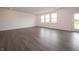Bright, open living room with dark wood floors and large windows offering plenty of natural light at 210 Aster Way, Greenfield, IN 46140