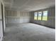 A large, unfinished living room with bright windows at 210 Aster Way, Greenfield, IN 46140