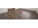 Bright, airy living space with elegant dark-toned flooring, white walls, and minimalist design at 210 Aster Way, Greenfield, IN 46140