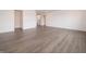 Expansive living area featuring sleek, dark-toned flooring, neutral decor, and ample natural light at 210 Aster Way, Greenfield, IN 46140