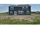 View of the rear exterior with blue siding and white framed windows at 210 Aster Way, Greenfield, IN 46140