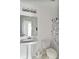Bright bathroom features a pedestal sink, decorative shower curtain, and sleek lighting at 2138 Rossington Ln, Indianapolis, IN 46229