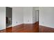A bedroom view showing the hardwood floor and a doorway into an ensuite bathroom at 2138 Rossington Ln, Indianapolis, IN 46229