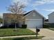 Traditional home with well-kept lawn, front yard tree and 2 car garage at 2138 Rossington Ln, Indianapolis, IN 46229