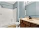Clean bathroom features a shower, wooden vanity, and a blue painted wall at 2270 Brightwell Pl, Indianapolis, IN 46260