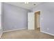 This comfortable bedroom features neutral carpet, a ceiling fan, and pale purple painted walls at 2270 Brightwell Pl, Indianapolis, IN 46260