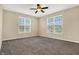 A spacious bedroom with two windows with blinds and a ceiling fan for comfortable living at 2270 Brightwell Pl, Indianapolis, IN 46260