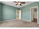 Comfortable bedroom with a ceiling fan and open doorway to a tiled bathroom at 2270 Brightwell Pl, Indianapolis, IN 46260