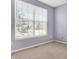 The neutral bedroom features a window providing natural light, and pale purple painted walls at 2270 Brightwell Pl, Indianapolis, IN 46260