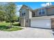 Attractive townhouse with a two-car garage, a well-maintained lawn, and charming curb appeal at 2270 Brightwell Pl, Indianapolis, IN 46260