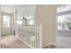 Second-floor hallway showcasing an overlook and connecting to a bedroom with natural light at 2270 Brightwell Pl, Indianapolis, IN 46260