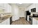 Well-lit kitchen with neutral countertops, stainless steel appliances, and wood flooring at 2270 Brightwell Pl, Indianapolis, IN 46260
