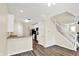 Open kitchen with stainless steel appliances, breakfast bar, and wood floors at 2270 Brightwell Pl, Indianapolis, IN 46260
