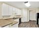 Bright kitchen featuring wood floors, white cabinets, and stainless steel appliances at 2270 Brightwell Pl, Indianapolis, IN 46260