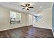 Open living room area with a fan, large window, and staircase; modern, neutral palette at 2270 Brightwell Pl, Indianapolis, IN 46260