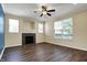 Bright living room showcasing a fireplace, large windows with exterior views and a ceiling fan at 2270 Brightwell Pl, Indianapolis, IN 46260