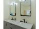 Modern bathroom featuring double vanity with gray cabinets, marble countertop, and sleek black fixtures at 2302 Prospect St, Indianapolis, IN 46203