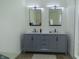 Modern bathroom featuring double vanity with gray cabinets, marble countertop, and sleek black fixtures at 2302 Prospect St, Indianapolis, IN 46203