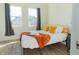Well-lit bedroom with a cozy bed adorned with colorful cushions and a soft blanket at 2302 Prospect St, Indianapolis, IN 46203