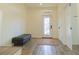Entryway with wood-look floors, a bench, a decorative rug, and a view of the front door at 2302 Prospect St, Indianapolis, IN 46203