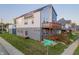 Striking exterior showcasing a two-story home with modern design, wooden balcony, and street views at 2302 Prospect St, Indianapolis, IN 46203