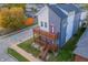 Modern two-story home featuring a gray and white color scheme and a double wooden balcony at 2302 Prospect St, Indianapolis, IN 46203