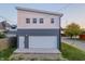 Detached two-car garage features a white door, modern design, and gray and white exterior paint at 2302 Prospect St, Indianapolis, IN 46203