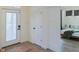 Hallway view with a decorative rug, bedroom access, and a glass-paneled front door at 2302 Prospect St, Indianapolis, IN 46203
