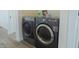 Modern laundry appliances for convenient washing, alongside shelves with washing powder and household items at 2302 Prospect St, Indianapolis, IN 46203