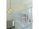 Loft area with white railings, a unique light fixture, and a view down to the entrance at 2302 Prospect St, Indianapolis, IN 46203