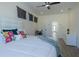 Comfortable main bedroom featuring a ceiling fan, a large window, and modern decor at 2302 Prospect St, Indianapolis, IN 46203