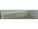 Close up showing the bench and mosaic floor in a modern walk in shower at 2302 Prospect St, Indianapolis, IN 46203