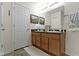 Well-lit bathroom with dual sinks, vanity, and ample storage at 2427 Apple Tree Ln, Indianapolis, IN 46229
