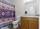 The bathroom features a modern vanity, toilet, and a colorful shower curtain for added privacy and style at 2427 Apple Tree Ln, Indianapolis, IN 46229