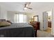 Bright bedroom with ceiling fan, area rug, and a dresser with a large mirror at 2427 Apple Tree Ln, Indianapolis, IN 46229