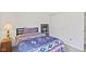Clean bedroom with carpeted flooring, side table, and sliding closet door at 2427 Apple Tree Ln, Indianapolis, IN 46229