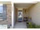 Inviting porch with a cozy seat, decorative wreath, and cheerful flower pots that enhance the home's curb appeal at 2427 Apple Tree Ln, Indianapolis, IN 46229