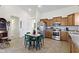 Functional kitchen equipped with stainless steel appliances, wooden cabinetry, and a compact dining area at 2427 Apple Tree Ln, Indianapolis, IN 46229