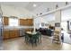 Open-concept kitchen featuring wooden cabinets, stainless steel appliances, and an adjacent dining area at 2427 Apple Tree Ln, Indianapolis, IN 46229