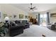 Spacious living room featuring vaulted ceilings, recessed lighting, and sliding glass door to the outside patio at 2427 Apple Tree Ln, Indianapolis, IN 46229