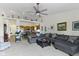 Open floor plan living room with ceiling fan, open to the kitchen, and filled with natural light at 2427 Apple Tree Ln, Indianapolis, IN 46229