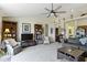Inviting living area with vaulted ceilings, recessed lighting, ceiling fan, and view of the kitchen at 2427 Apple Tree Ln, Indianapolis, IN 46229