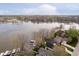 Stunning aerial view of waterfront homes on a tranquil lake surrounded by mature trees and lush landscapes at 2428 Hawthorn Pl, Noblesville, IN 46062