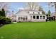 Expansive backyard featuring lush green lawn and stone-accented exterior with large picture windows at 2428 Hawthorn Pl, Noblesville, IN 46062