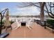 Backyard patio with lake view, Adirondack chairs, a fire pit, and a grill at 2428 Hawthorn Pl, Noblesville, IN 46062